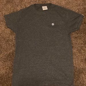 This is a grey T-shirt with sunflowers on the back.